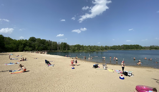 Image of Menomonie Park beach in Hubertus, WI showing sunbathers and swimmers.